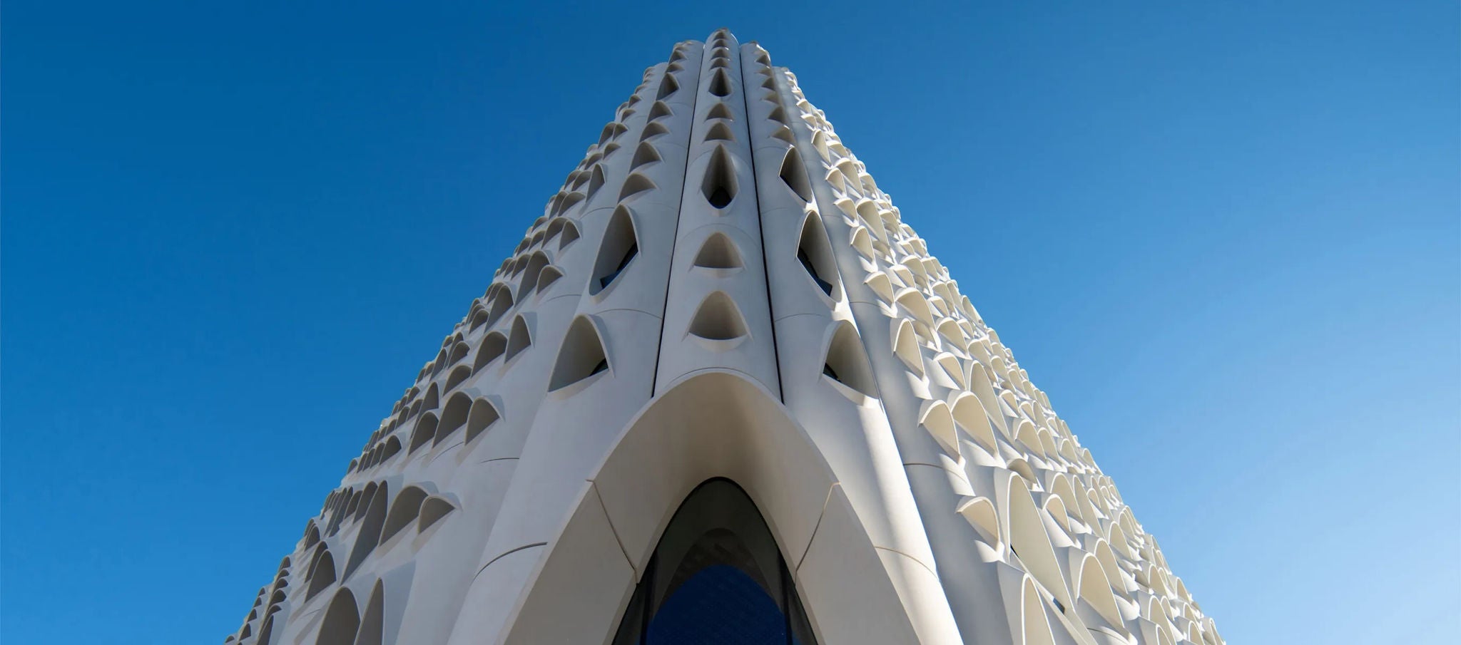 Low-angle shot of Populus, facade has teardrop-shaped openings, unique architecture