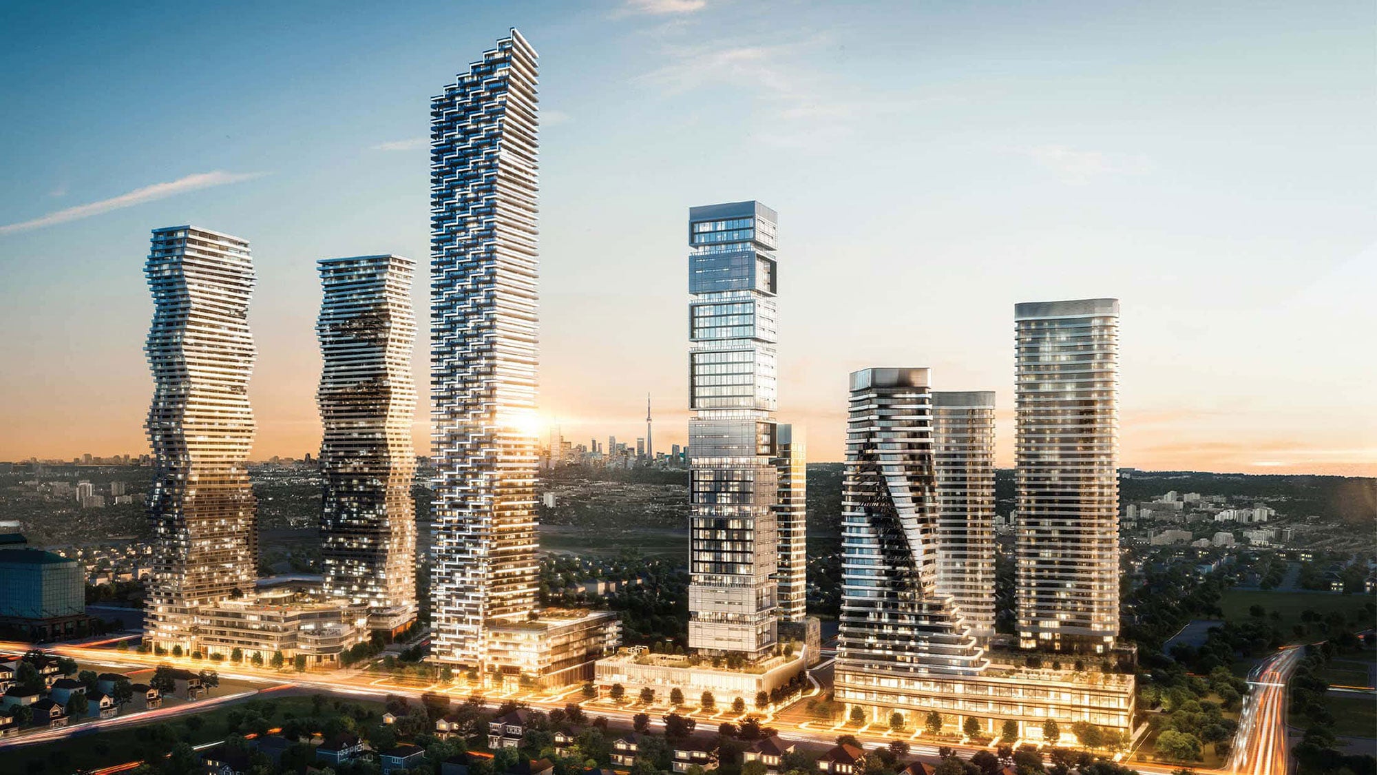 Five large, geometric towers rising at dusk in front of a broader cityscape