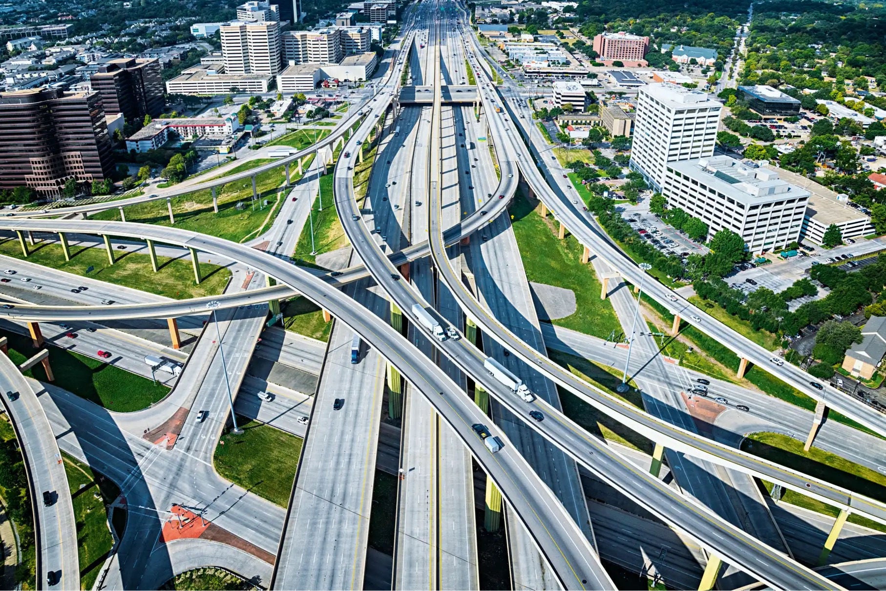 As viewed from overhead, the intersection of at least two highways and several on- and off-ramps, access roads and bridges.
