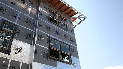 The exterior of a building under construction as seen from below