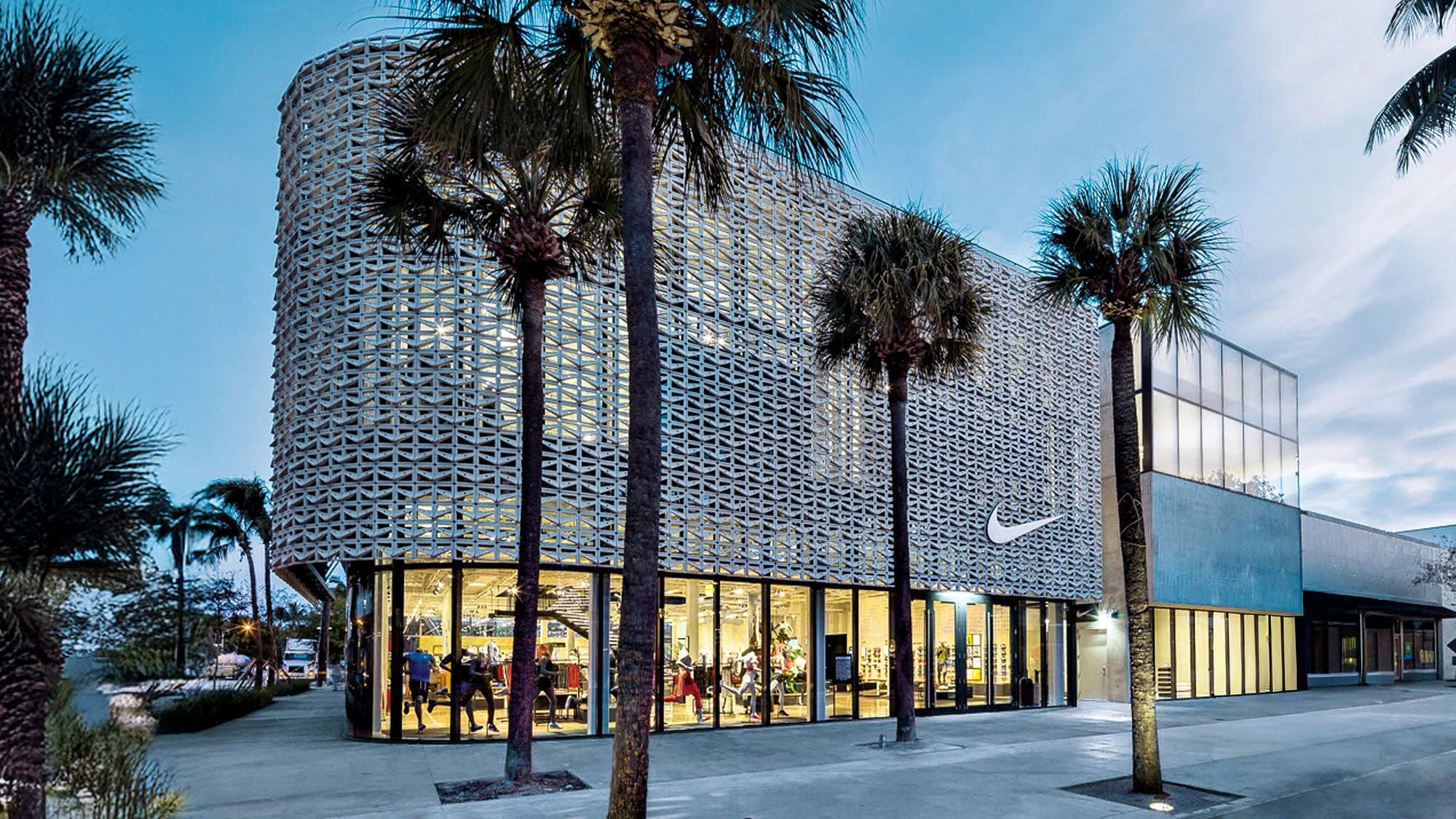 The intricate concrete facade of a retail store set amongst palm trees