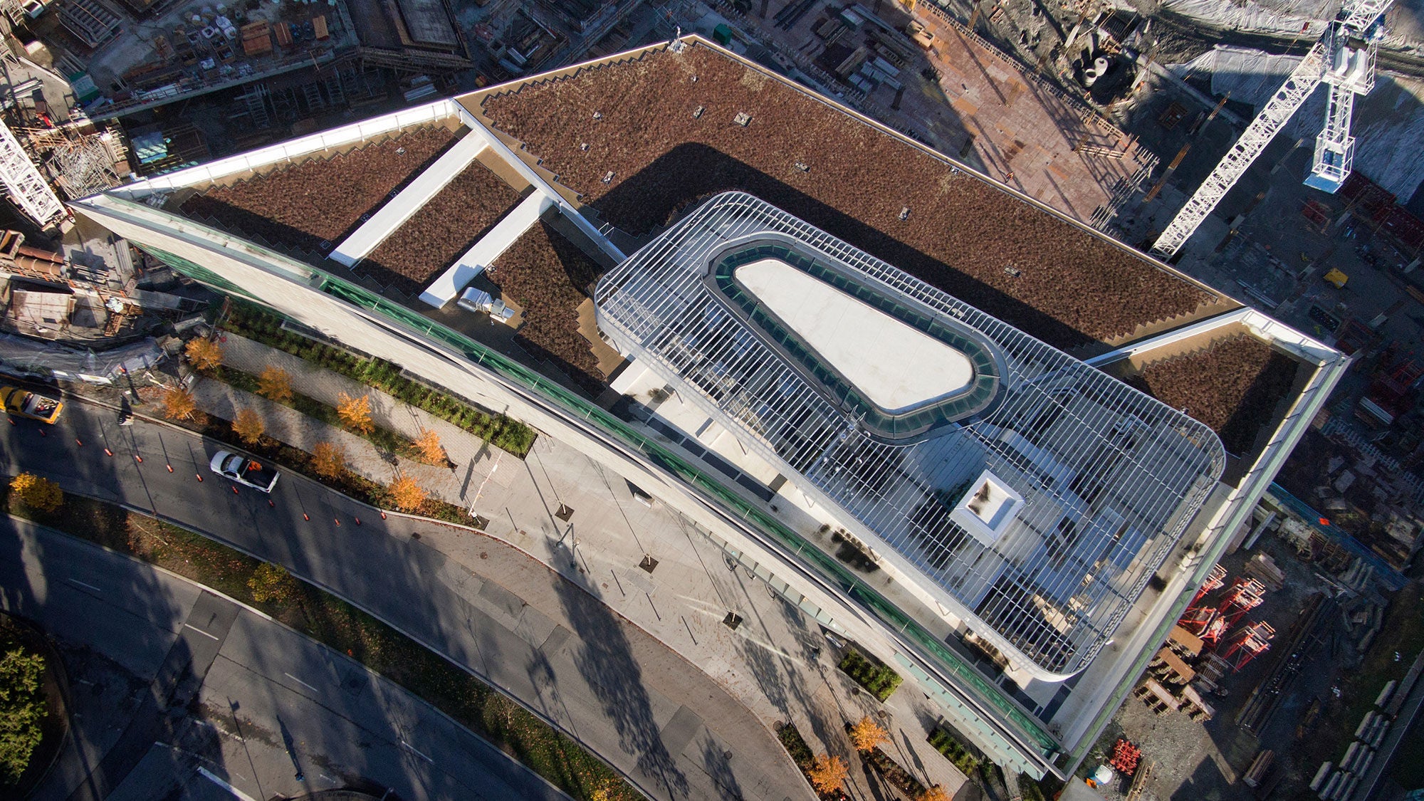 An aerial view of a rectangular, multi-story library in the midst of the surrounding city.