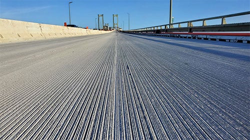 Close up of a bridge roadbed overlay stretching into the distance